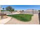 Spacious backyard with a well-kept lawn, built-in barbecue, and charming string lights at 3784 E Simpson Ct, Gilbert, AZ 85297