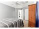 Inviting bedroom with ceiling fan, a wooden armoire, and natural light creating a tranquil space at 3784 E Simpson Ct, Gilbert, AZ 85297