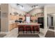 Vaulted ceiling kitchen features ample cabinetry, an island with seating and black appliances at 3784 E Simpson Ct, Gilbert, AZ 85297