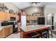 Bright kitchen with wooden cabinets, a kitchen island with seating and modern appliances at 3784 E Simpson Ct, Gilbert, AZ 85297