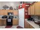 Bright kitchen with wooden cabinets, modern appliances and tile backsplash at 3784 E Simpson Ct, Gilbert, AZ 85297