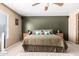Bedroom with ceiling fan and olive accent wall at 3784 E Simpson Ct, Gilbert, AZ 85297