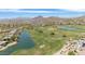 Aerial view of a community golf course with ponds and surrounding mountains at 3812 N Barron --, Mesa, AZ 85207
