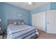 Comfortable bedroom with blue walls, carpeted floors, and a full sized bed, closet, and ceiling fan at 3812 N Barron --, Mesa, AZ 85207