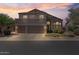 Night shot of a home with a three-car garage, well-maintained lawn, and manicured bushes at 3812 N Barron --, Mesa, AZ 85207