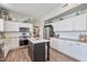 Modern kitchen with white cabinets, stainless steel appliances, and a center island, offering ample workspace at 3812 N Barron --, Mesa, AZ 85207