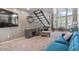 Comfortable living room with TV and a modern staircase plus a picturesque window view at 3812 N Barron --, Mesa, AZ 85207