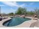 Backyard featuring a pool with rock waterfall feature, patio, and desert landscaping at 3812 N Barron --, Mesa, AZ 85207