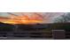 Scenic sunset view over neighborhood rooftops, showcasing vibrant orange hues and mountain views from the property at 3812 N Barron --, Mesa, AZ 85207