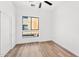Bright bedroom with modern flooring, ceiling fan and a large window with a view at 4220 N 32Nd St # 2, Phoenix, AZ 85018