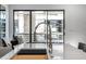 Modern kitchen with an industrial style chrome faucet and sink integrated into the light gray countertop at 4220 N 32Nd St # 2, Phoenix, AZ 85018
