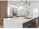 Stunning kitchen island with seating boasts modern pendant lights and a sleek faucet, perfect for entertaining and daily living at 4220 N 32Nd St # 2, Phoenix, AZ 85018