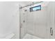Modern walk-in shower boasts a sleek glass door, marbled walls, and a window for natural light, enhancing the spa feel at 4220 N 32Nd St # 2, Phoenix, AZ 85018