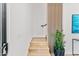 Modern wood staircase with a sleek black handrail and a decorative plant at 4220 N 32Nd St # 2, Phoenix, AZ 85018