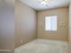 A simple bedroom with neutral walls, carpet, and standard window at 43302 W Bunker Dr, Maricopa, AZ 85138