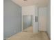 A bedroom featuring blue walls, standard window, carpet, closet with mirrored doors, and ceiling fan at 43302 W Bunker Dr, Maricopa, AZ 85138