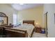 Cozy bedroom features neutral walls, plush carpeting, and a large window at 43302 W Bunker Dr, Maricopa, AZ 85138