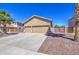Single-story home with a three-car garage, desert landscaping, palm trees and neutral color scheme at 43302 W Bunker Dr, Maricopa, AZ 85138