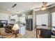 Open-concept kitchen and dining area with stainless steel appliances and white cabinets at 43302 W Bunker Dr, Maricopa, AZ 85138