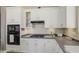 Modern kitchen with stainless steel appliances, granite countertops and sleek cabinets at 43302 W Bunker Dr, Maricopa, AZ 85138