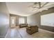 Spacious living room featuring tile flooring, neutral wall color, large windows, and comfortable seating at 43302 W Bunker Dr, Maricopa, AZ 85138