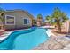 Inviting pool area with palm trees and rock features, perfect for outdoor relaxation and entertaining at 43302 W Bunker Dr, Maricopa, AZ 85138