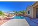 Private pool surrounded by palm trees and patio space, ideal for outdoor enjoyment and relaxation at 43302 W Bunker Dr, Maricopa, AZ 85138