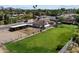 Aerial view of the property's pasture, barn, and outbuildings at 4502 W Greenway Rd, Glendale, AZ 85306