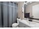 Clean bathroom with a modern vanity, and a shower featuring a shower curtain for privacy at 4502 W Greenway Rd, Glendale, AZ 85306