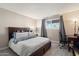 Comfortable bedroom with wood-look tile flooring, window, and side desk for working or studying at 4502 W Greenway Rd, Glendale, AZ 85306