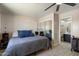 Comfortable bedroom with closet and attached bath, features wood-look tile flooring and ample lighting at 4502 W Greenway Rd, Glendale, AZ 85306