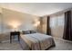 Inviting bedroom with wood-look tile flooring, with side lamps, and window with natural light at 4502 W Greenway Rd, Glendale, AZ 85306