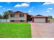 Charming home featuring well-manicured lawn and a driveway leading to a spacious garage at 4502 W Greenway Rd, Glendale, AZ 85306