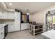 Bright kitchen featuring white cabinets, a modern island, and stylish lighting fixtures at 4502 W Greenway Rd, Glendale, AZ 85306