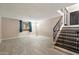 Open floor plan with tile floors, staircase, and access to the front door and second story at 4502 W Greenway Rd, Glendale, AZ 85306