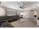 Open-concept living space with tile floors, a sectional sofa, and modern ceiling fans at 4502 W Greenway Rd, Glendale, AZ 85306