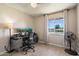 Bright home office with a large window, great natural light, and wood-look tile flooring at 4502 W Greenway Rd, Glendale, AZ 85306