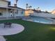 Backyard with artificial turf, fire pit area, and a lovely private swimming pool at 4517 S Grandview Ave, Tempe, AZ 85282