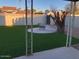 Well-maintained backyard with artificial turf, fire pit, and decorative tree stump at 4517 S Grandview Ave, Tempe, AZ 85282