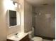 Bathroom featuring a modern sink, toilet, and a spacious walk-in shower with marble-style tile at 4517 S Grandview Ave, Tempe, AZ 85282