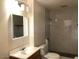 Bathroom with modern fixtures, granite countertops, tiled shower, and a toilet at 4517 S Grandview Ave, Tempe, AZ 85282