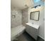 Well-lit bathroom featuring a tile shower and grey vanity with a square mirror at 4517 S Grandview Ave, Tempe, AZ 85282