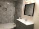Modern bathroom with a vanity, mirror, and a tiled shower, designed for comfort and style at 4517 S Grandview Ave, Tempe, AZ 85282