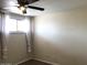 Bedroom features a ceiling fan and window, providing natural light and ventilation at 4517 S Grandview Ave, Tempe, AZ 85282