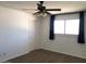 Bedroom with a ceiling fan, a large window with curtains, and a closet at 4517 S Grandview Ave, Tempe, AZ 85282