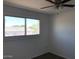 Bedroom featuring large window with view, ceiling fan, and neutral walls at 4517 S Grandview Ave, Tempe, AZ 85282