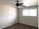 A bright bedroom with a ceiling fan and a window, offering natural light and ventilation at 4517 S Grandview Ave, Tempe, AZ 85282