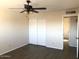 Bright bedroom featuring wood-look floors, closet, and ceiling fan at 4517 S Grandview Ave, Tempe, AZ 85282