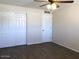 Bright bedroom featuring wood-look flooring, a ceiling fan, and a closet for ample storage space at 4517 S Grandview Ave, Tempe, AZ 85282
