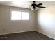 Bedroom features a ceiling fan and a window, providing ample natural light and air circulation at 4517 S Grandview Ave, Tempe, AZ 85282
